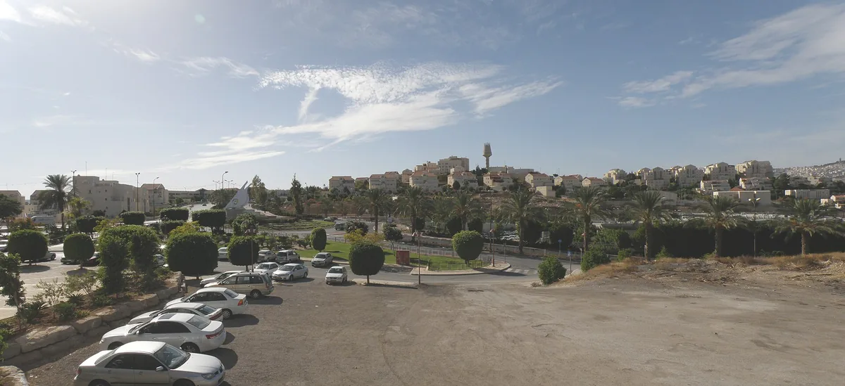 Panoramic view over Ma'ale Adumim from the mall, with a car park in the foreground